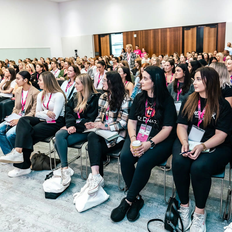 Attendees seated in a business-track session